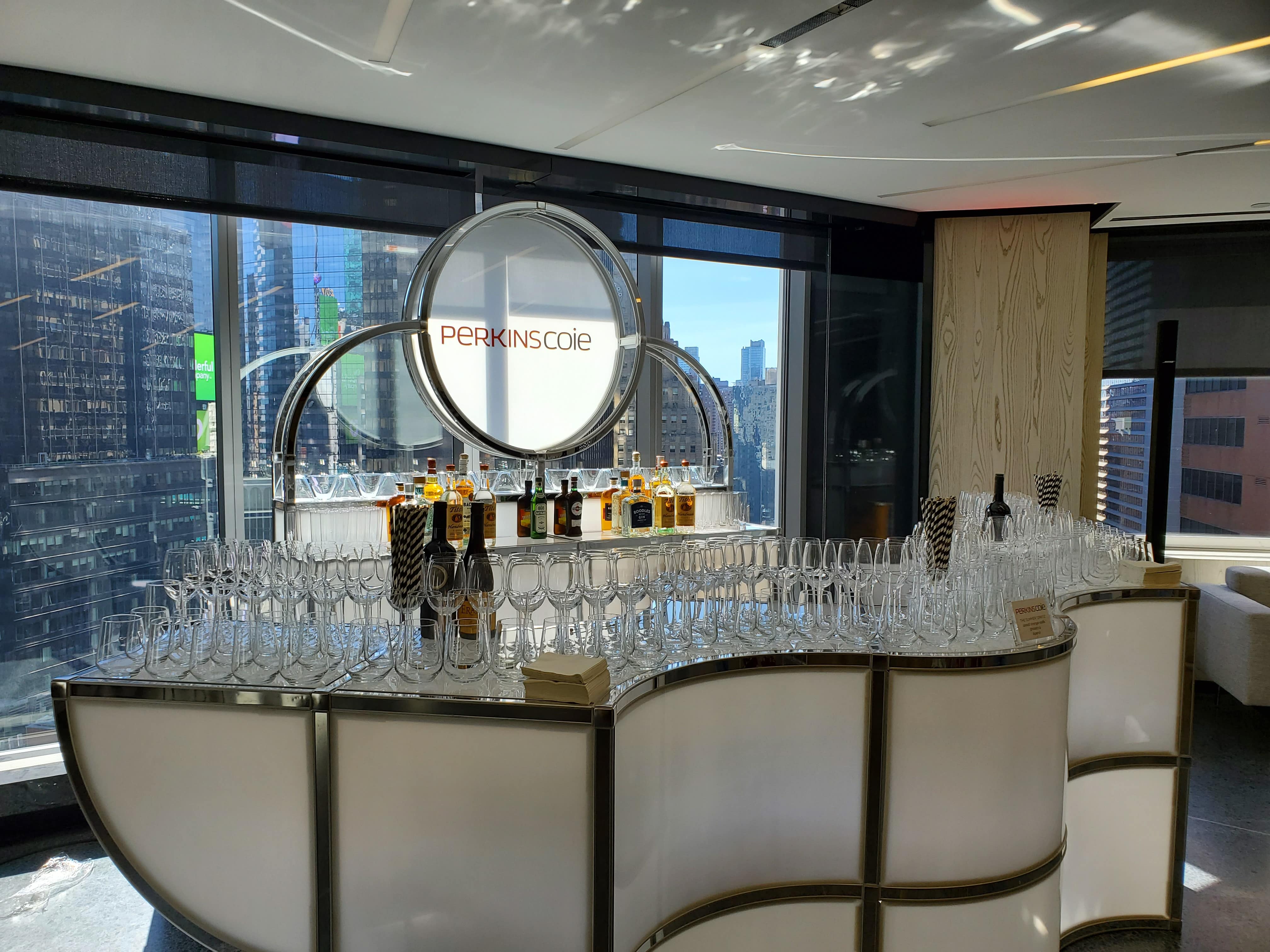Custom event furniture setup for a brand activation featuring branded bars, lounge seating, cocktail tables, and attendee engagement areas