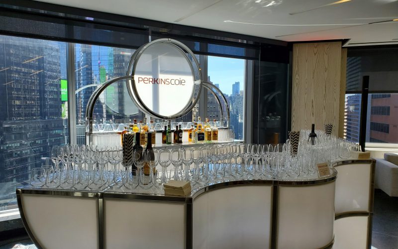 Custom event furniture setup for a brand activation featuring branded bars, lounge seating, cocktail tables, and attendee engagement areas