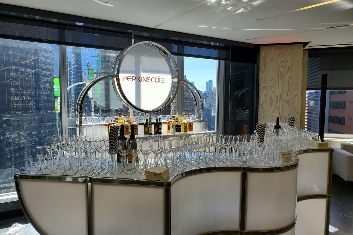 Custom event furniture setup for a brand activation featuring branded bars, lounge seating, cocktail tables, and attendee engagement areas