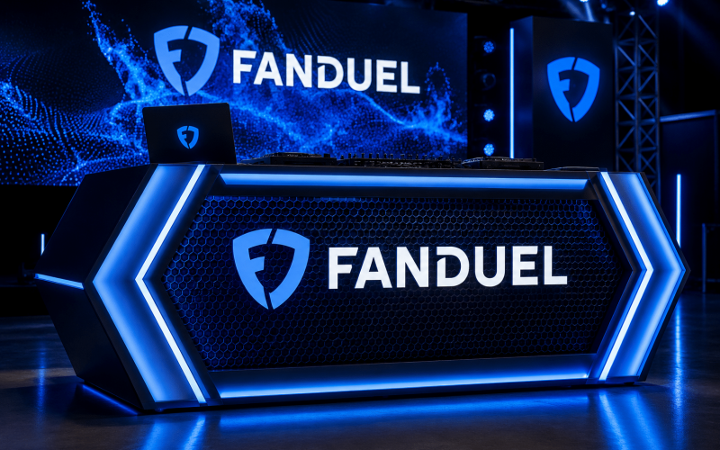 Custom illuminated DJ booth with branded graphics, LED lighting, and experiential event fabrication for corporate events and brand activations.