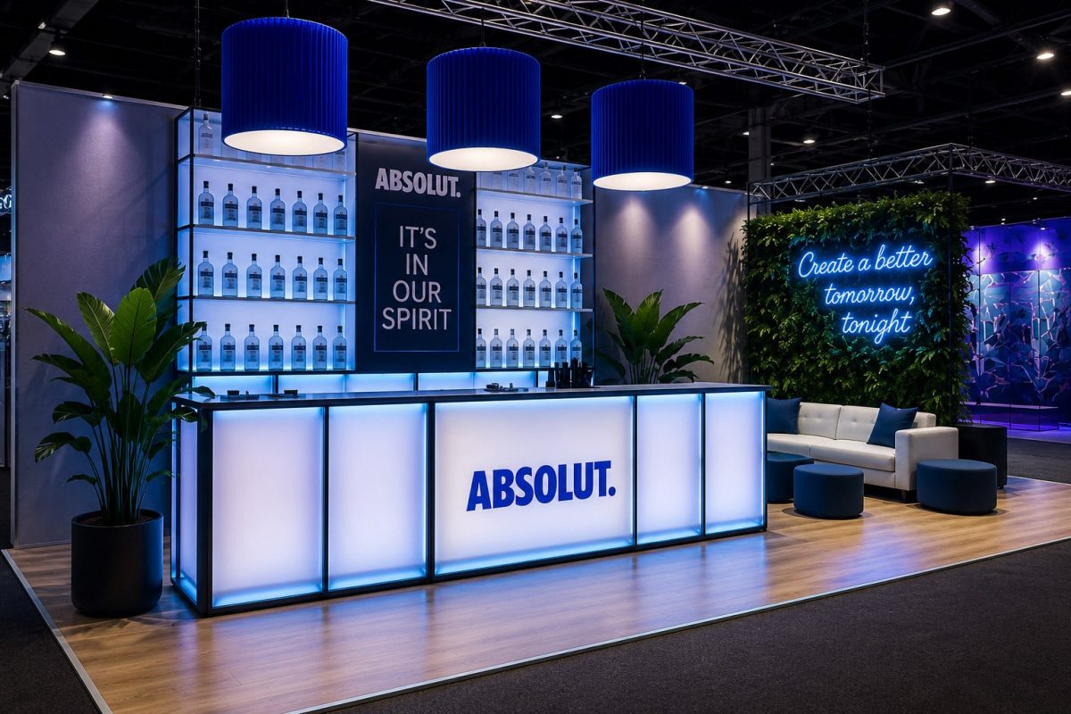 Modern Absolut branded modular trade show booth with illuminated bar, experiential lounge seating, LED lighting, and custom fabricated activation design.